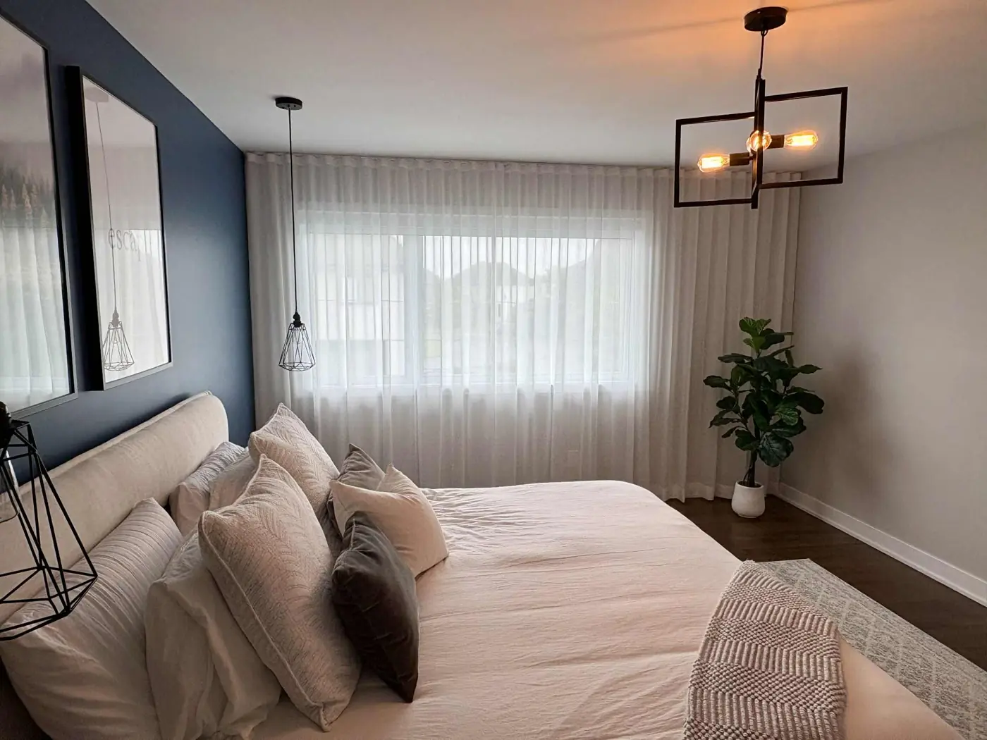 Chambre principale avec voilage ripplefold blanc sur toute la largeur du mur de la fenêtre